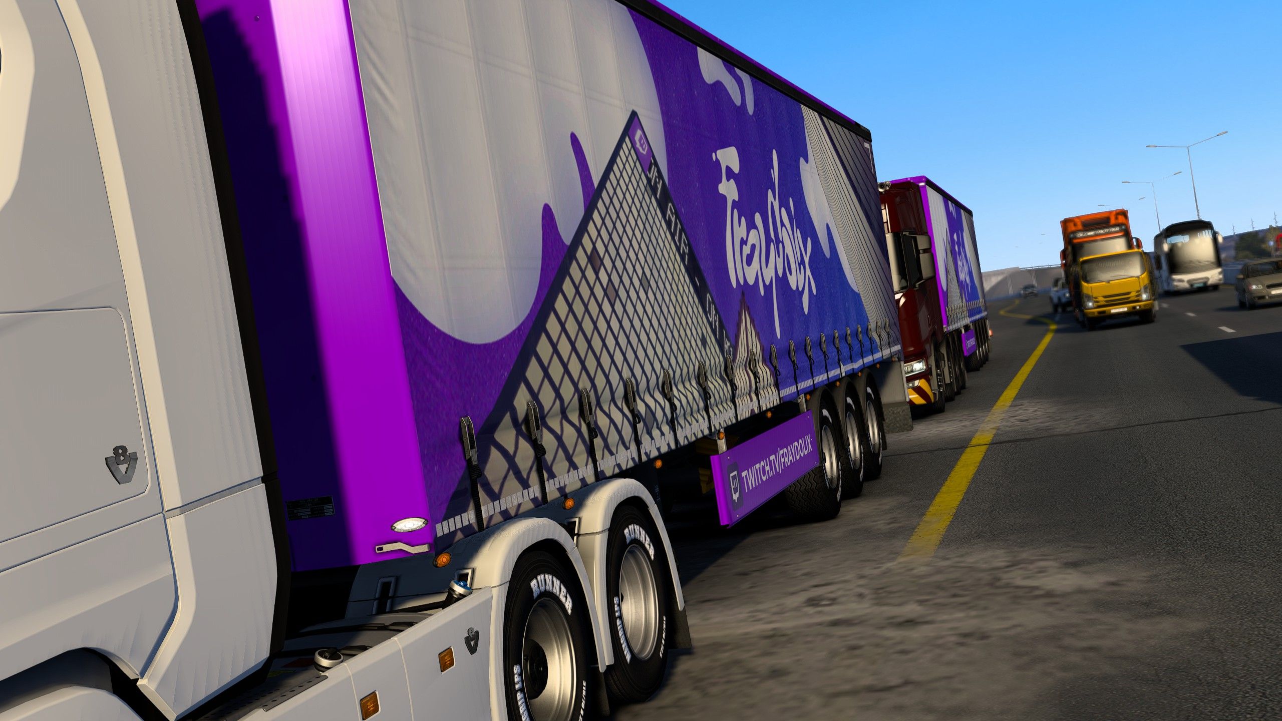 Two Fraydolix-branded trailers in highway traffic