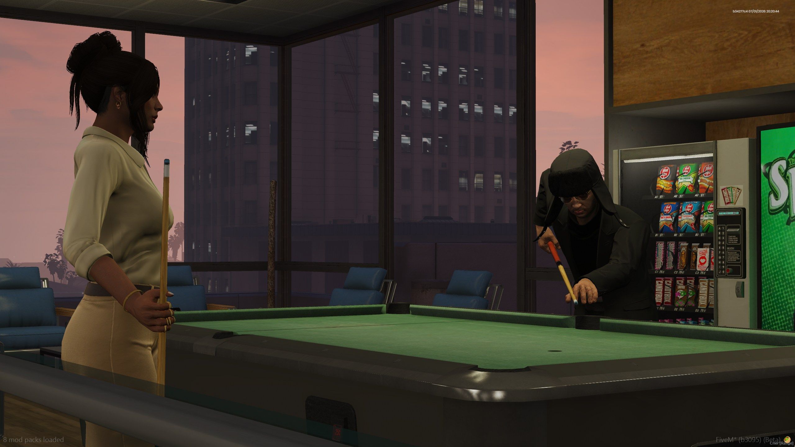 Two civilians around the pool table at the station
